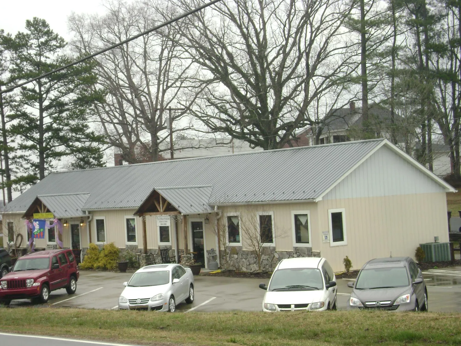 Gray metal roof with timber entry brackets on a small commercial building in Princeton